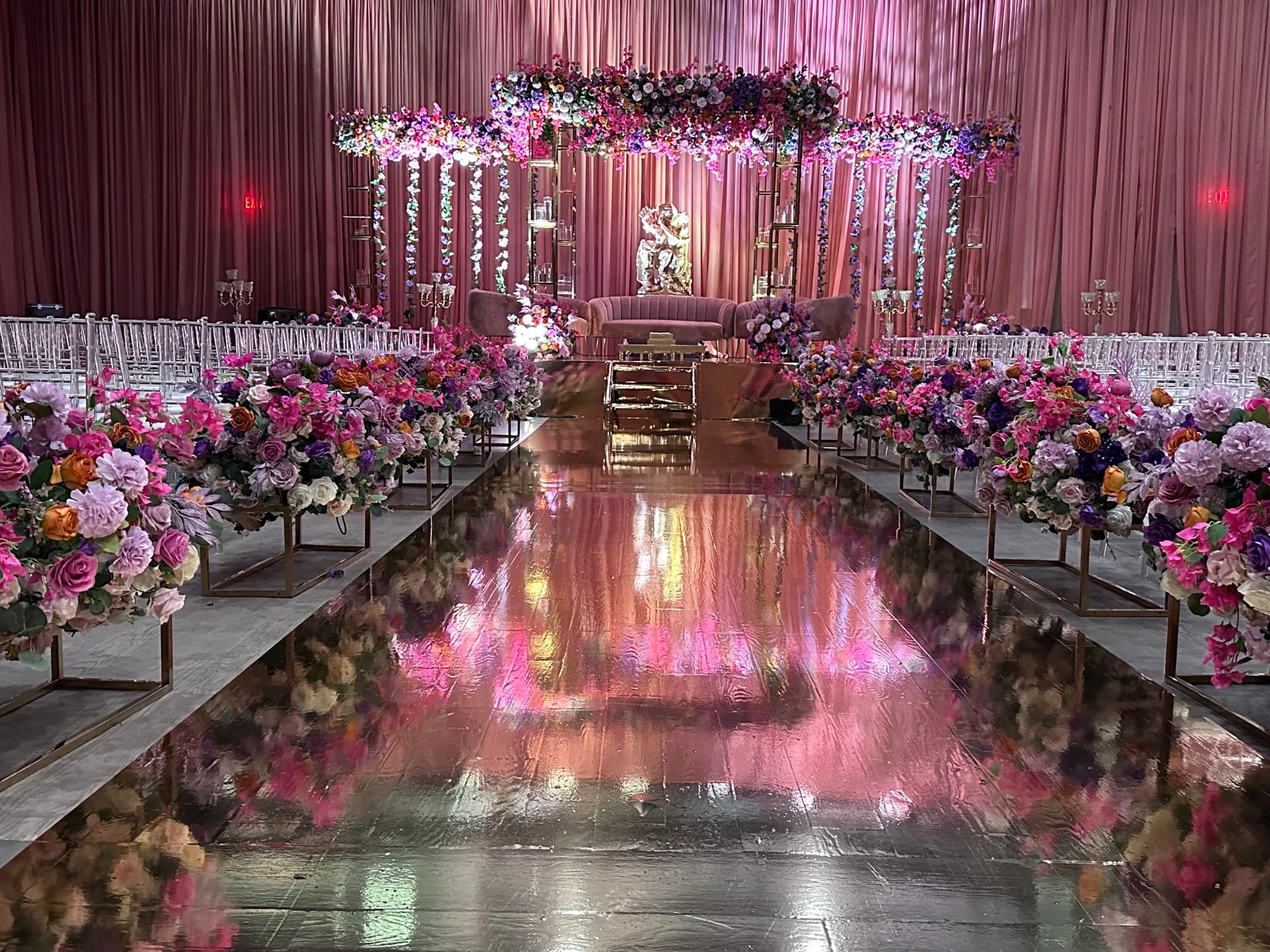 Floral stage and mirrored aisle set for a wedding ceremony at Palacio Event Centre in Mississauga